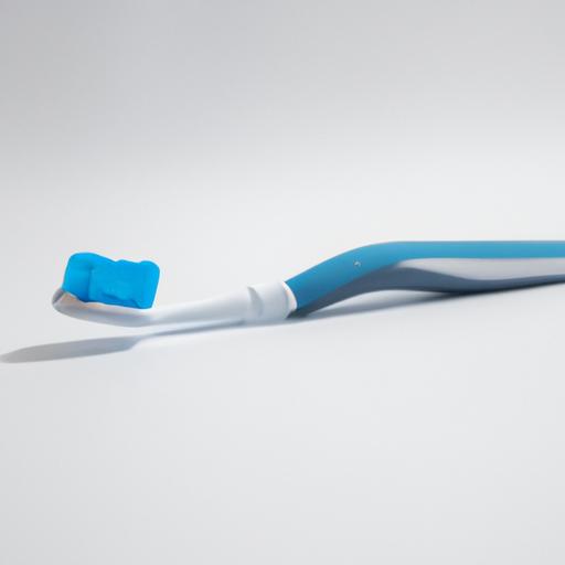 A close-up of a toothbrush with soft bristles and an ergonomic handle.